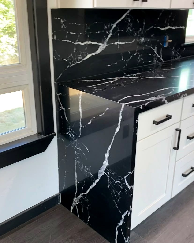 Black and white marble waterfall island installed by Diamond Countertops
